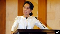 FILE - Myanmar State Counsellor Aung San Suu Kyi speaks at a memorial ceremony to mark one month from the killing of Ko Ni, prominent legal adviser to the government, and taxi driver Ne Win, Feb.26, 2017, in Yangon, Myanmar. 