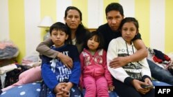 FILE - Jeanette Vizguerra (2-L) poses with her husband Salvador Baez (2n-R) and their children in the First Unitarian Society Church of Denver, in Denver, Colorado, Feb. 16, 2017. The family, undocumented immigrants, had taken refuge in the church for fear of being deported by Immigration and Customs Enforcement.