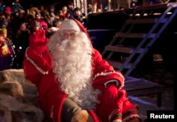 A man dressed as Santa Claus leaves for his annual Christmas journey from the Santa Claus Village at the Arctic Circle in Rovaniemi, Finnish Lapland, Dec. 23, 2014.