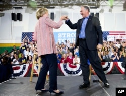 Democratic presidential candidate Hillary Clinton fist bumps Sen. Tim Kaine, D-Va., after speaking at a rally at Northern Virginia Community College in Annandale, Thursday, July 14, 2016.