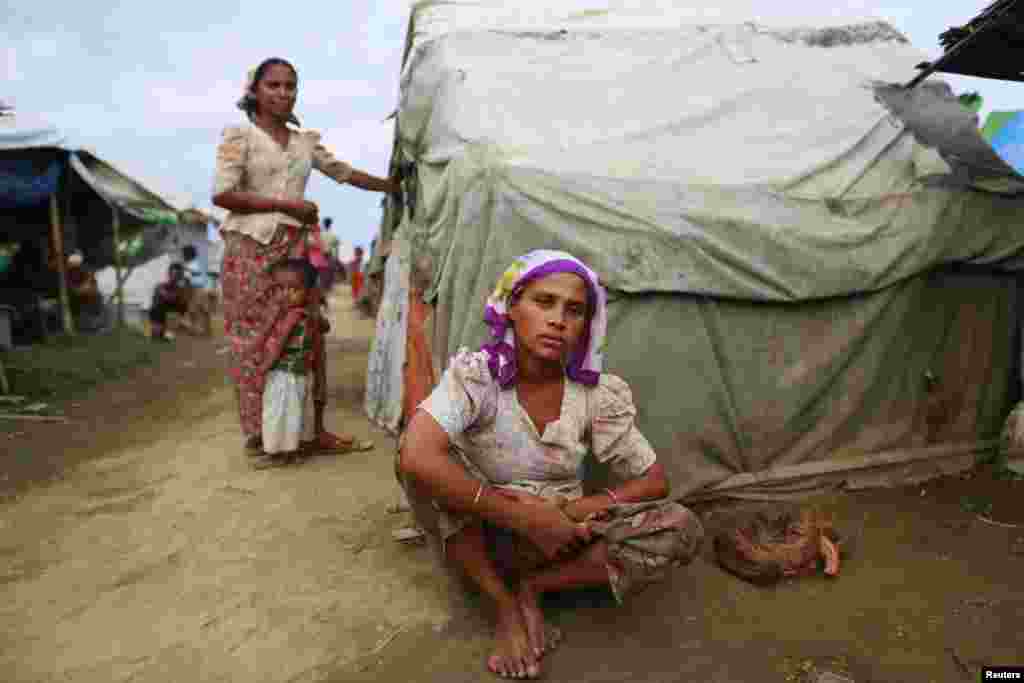 Sinnuyar Baekon sits in front of her hut at a refugee camp outside Sittwe, the capital city of the Rakhine state, Myanmar, June 9, 2014.