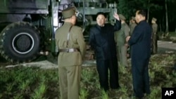 In this image made from video by North Korea's KRT, July 28, 2017, North Korean leader Kim Jong Un gestures at the site of a missile test at an undisclosed location in North Korea.
