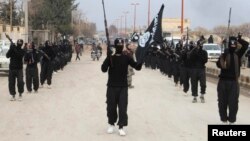 Yihadistas del Estado Islámico de Irak y el Levante desfilan tras capturar la ciudad de Tel Abyad, en Siria.