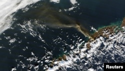 FILE - A plume of smoke from Alaska's Pavlof volcano is pictured in this Nov. 14, 2014 NASA handout satellite image. 