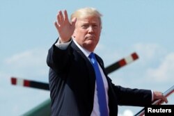 FILE - U.S. President Donald Trump waves as he boards Air Force One at Joint Base Andrews outside Washington, June 9, 2017.