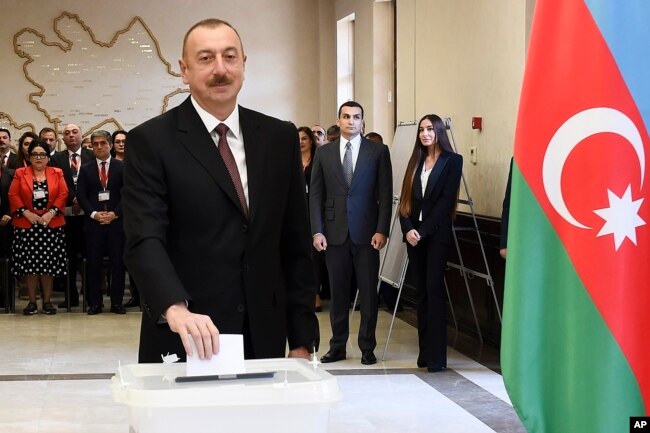 FILE - Azerbaijan President Ilham Aliyev casts his ballot at a polling station during presidential elections in Baku, Azerbaijan, April 11, 2018.