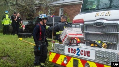 Les pompiers interviennent au lieu où un arbre tombé sur une maison a tué deux personnes dans l’ouragan Florence à Wilmington, en Caroline du Nord, le 14 septembre 2018.