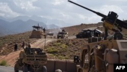FILE - U.S. Army personnel from NATO and Afghan commando forces are pictures in a checkpoint during a patrol against Islamic State militants at the Deh Bala district in the eastern province of Nangarhar Province.