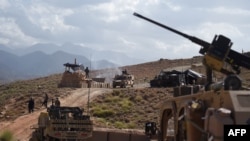 FILE - In this photo taken on July 7, 2018, US Army from NATO and Afghan commando forces are pictures in a checkpoint during a patrol against Islamic State militants at the Deh Bala district in the eastern province of Nangarhar Province.