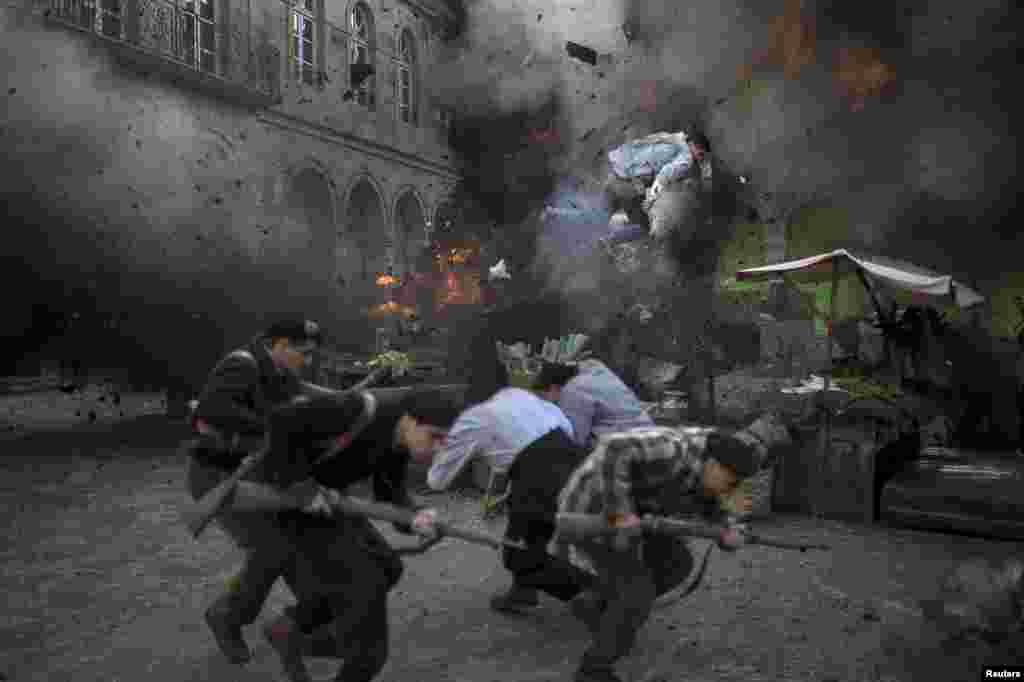 A stuntman flies through the air following an explosion during the filming of Gernika directed by Koldo Serra in the Basque town of Guernica, northern Spain, June 17, 2015. The film centers on an American journalist reporting on the aerial bombing of the town during the Spanish Civil War by planes from Germany&#39;s Condor Legion, in aid of the nationalist military rebellion led by General Francisco Franco.