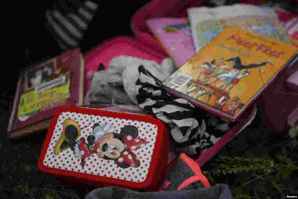 Passengers' belongings are pictured at the crash site of Malaysia Airlines flight MH17 before a visit by OSCE monitors, near the settlement of Grabovo in the Donetsk region, July 18, 2014. 