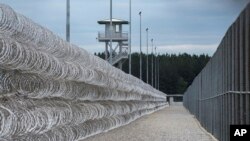 FILE - Razor wire protects a perimeter of the Lee Correctional Institution in Bishopville, South Carolina, Feb. 9, 2016.