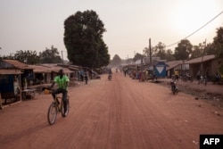 FILE - A man rides a bike in the main avenue of the town of Paoua, northwestern Central African Republic, Dec. 27, 2017.