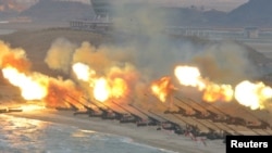 FILE - Artillery pieces are fired during a military drill at an unknown location in this undated photo released by North Korea's Korean Central News Agency (KCNA) on March 25, 2016.