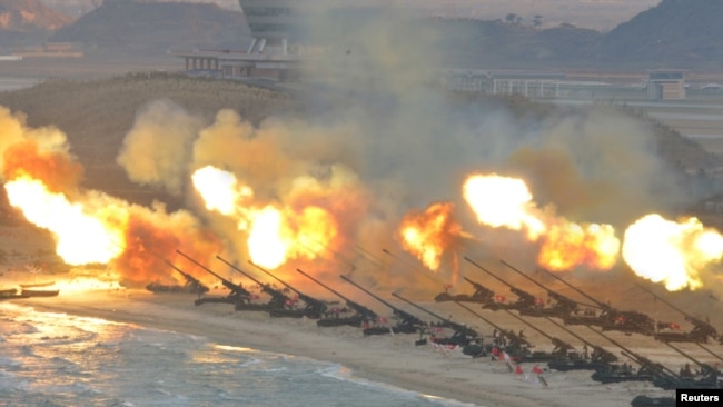 FILE - Artillery pieces are fired during a military drill at an unknown location in this undated photo released by North Korea's Korean Central News Agency (KCNA) on March 25, 2016.