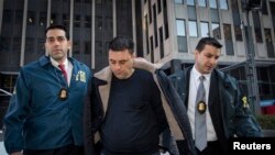 Gambino family associate Franco Lupoi is escorted by FBI agents from their Manhattan offices in New York Feb. 11, 2014.