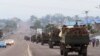 FILE - Congo military trucks carrying Congolese troops drive in a main street after violence erupted due to the delay of the presidential elections in Kinshasa, Democratic Republic of Congo, Sept. 20, 2016.