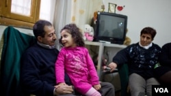 Daniel, an Armenian Orthodox from Syria, relaxes in Beirut with his 5-year-old daughter Antonella, while his mother-in-law looks on, December 2012. (VOA/V. Undritz)