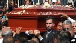 Alan Raul Garcia, son of Peru's late President Alan Garcia, carries the coffin of his father during the funeral procession in Lima, Peru, April 19, 2019. 