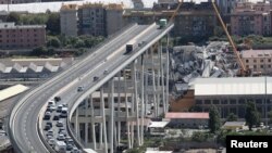 FILE - The collapsed Morandi Bridge is seen in the Italian port city of Genoa, Italy, Aug. 16, 2018. 