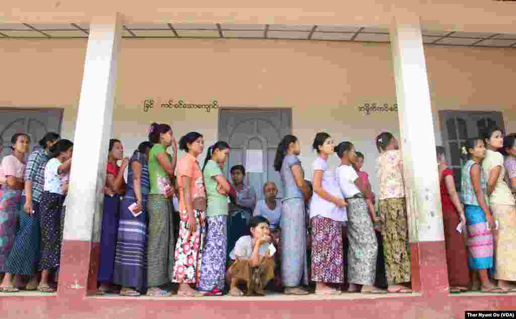 Voters are seen at a polling station in Yangon, Nov. 8, 2015.