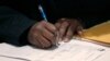 FILE - A job seeker fills out an application during a National Career Fairs job fair, in Chicago, Illinois. A tightening job market in Canada means international students in Canada are having difficulty finding work.