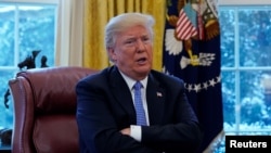 FILE - President Donald Trump speaks during an interview with Reuters at the White House in Washington, Jan. 17, 2018. 