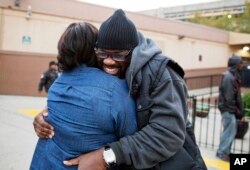 Darryl Hamlett embraces his fiancee, Beverly Conners, as he arrives off a bus from New York to spend the Thanksgiving holiday in Atlanta, Nov. 23, 2016.