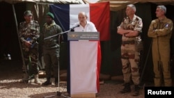 French Defense Minister Jean-Yves Le Drian addressing troops at a military encampment at a Malian air base, Gao, March 7, 2013.