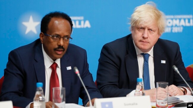 Britain's Foreign Secretary Boris Johnson listens during a National Security session as President of Somalia Mohamed Abdullahi Mohamed, left, speaks at the 2017 Somalia Conference in London, May 11, 2017. 