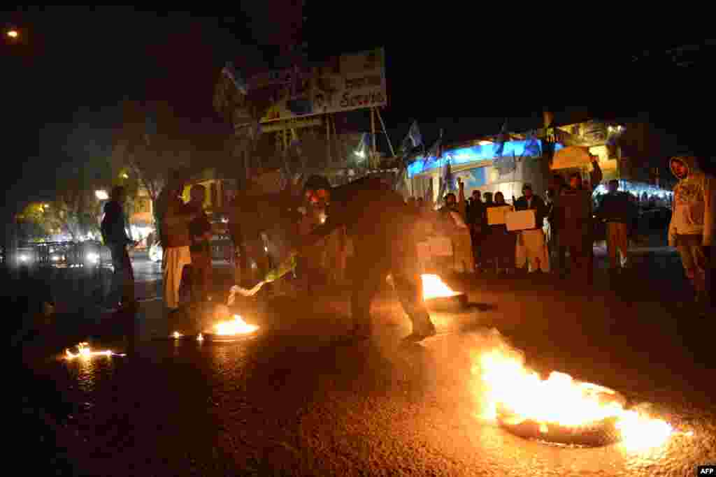 An activist of Jamaat-e-Islami Pakistan sets a tire on fire in a protest against the execution of a senior Bangladeshi opposition leader known as the &#39;Butcher of Mirpur&#39;, making him the first person to be put to death for massacres committed during the country&#39;s bloody 1971 war of independence, in Islamabad.