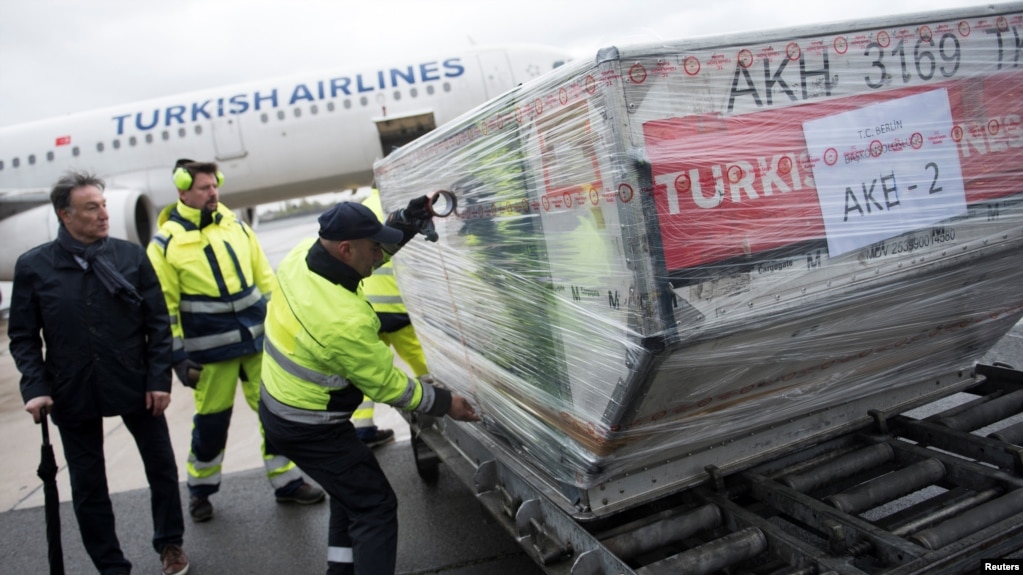 Officials load ballot boxes with votes from expatriates on the constitutional referendum from a truck onto a plane for shipment to Turkey at Tegel airport in Berlin, Germany, April 11, 2017.