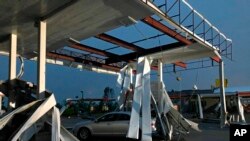 A car is trapped under the fallen metal roof of the Break Time gas station and convenience store in tornado-hit Jefferson City, Mo., May 23, 2019.