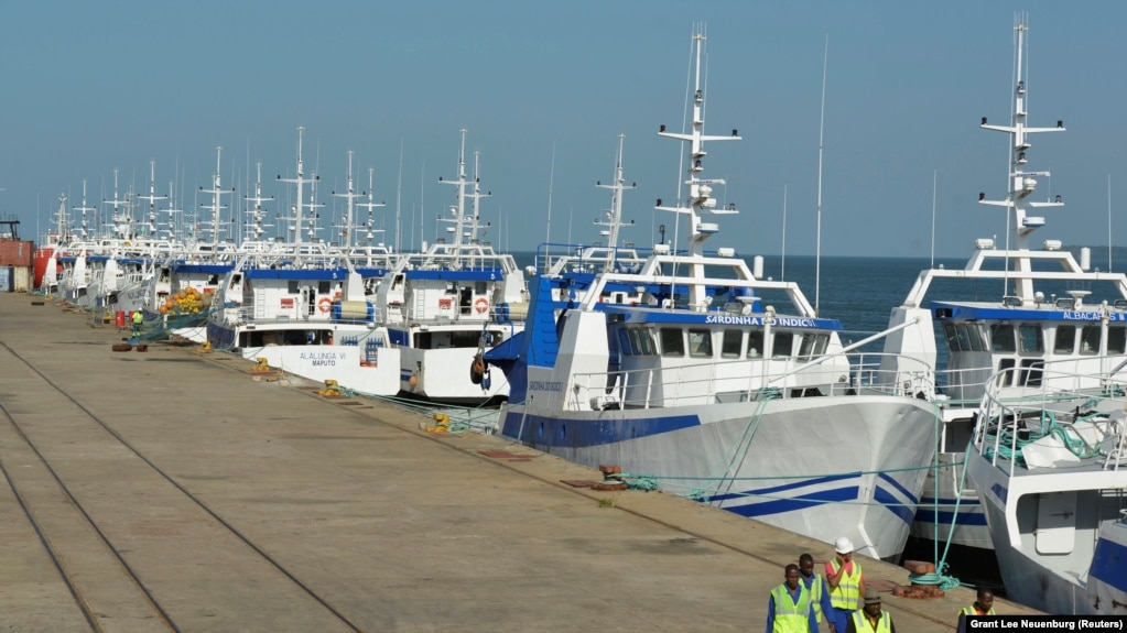 Patrulha de segurança passa por barcos da EMATUM na doca de Maputo.