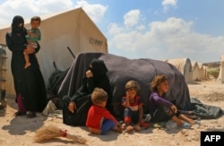 FILE - Displaced Syrians are seen at a camp in Kafr Lusin near the Bab al-Hawa border crossing with Turkey in the northern part of Syria's rebel-held Idlib province, Sept. 6, 2018.