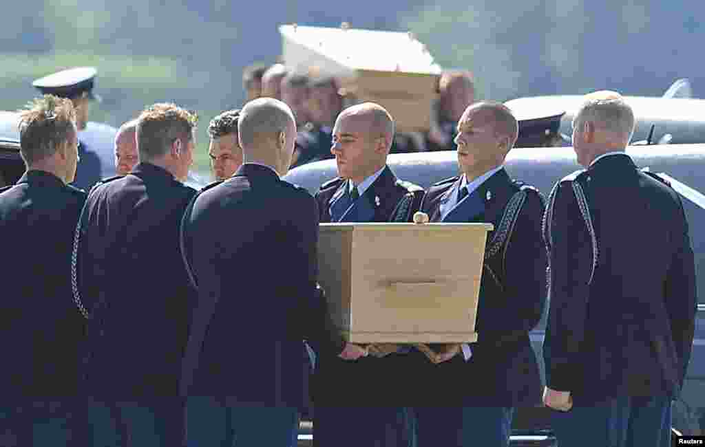 Coffins of the victims of Malaysia Airlines MH17 downed over rebel-held territory in eastern Ukraine are loaded into hearses during a national reception ceremony at Eindhoven Airport, Netherlands, July 23, 2014.