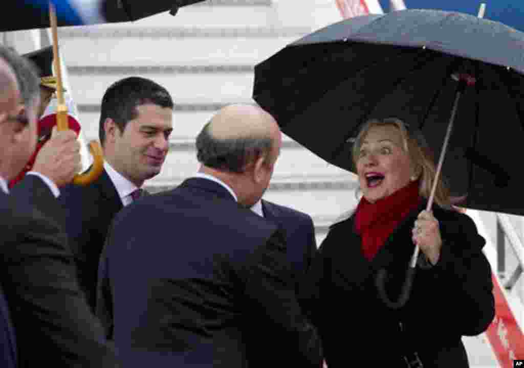 US Secretary of State Hillary Clinton is greeted by officials as she disembarks from her plane upon arrival at Tirana Rinas Airport in Tirana, Thursday, Nov. 1, 2012. Hillary Clinton arrived in EU-hopeful Albania on the last leg of her Balkans tour where
