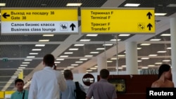 People walk inside the Moscow's Sheremetyevo airport, June 26, 2013. 