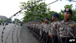 Barisan polisi di belakang kawat berduri di luar Istana presiden mengantisipasi demonstrasi anti-kenaikan BBM (19/11). (AFP/Romeo Gacad)