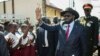 South Sudan President Salva Kiir waves as he greets schoolchildren at Juba International Airport in Juba on Sept. 13, 2018, after returning from the Ethiopian capital Addis Ababa where the latest peace agreement with opposition leader Riek Machar was finalized.