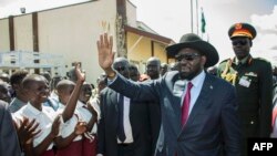 South Sudan President Salva Kiir greets schoolchildren at Juba International Airport on Sept. 13, 2018, after returning from the Ethiopian capital, Addis Ababa. There, the latest peace agreement with opposition leader Riek Machar was finalized.