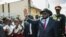 South Sudan President Salva Kiir waves as he greets schoolchildren at Juba International Airport in Juba on Sept. 13, 2018, after returning from the Ethiopian capital Addis Ababa where the latest peace agreement with opposition leader Riek Machar was finalized.