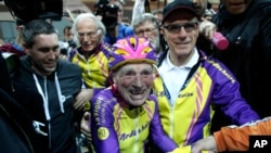 French cyclist Robert Marchand, 105, is cheered after setting a record for distance cycled in one hour, at the velodrome of Saint-Quentin en Yvelines, outside Paris, Wednesday, Jan. 4, 2017.