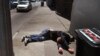 FILE - In this April 26, 2018, file photo, a man lies on the sidewalk beside a recyclable container in San Francisco, California. A record 621 people died of drug overdoses in San Francisco so far this year, a number far higher than the 173 deaths from CO
