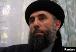 FILE - Gulbuddin Hekmatyar speaks to a reporter in 2002.