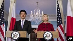 Secretary of State Hillary Clinton (R) speaks during a meeting with Japanese Foreign Minister Koichiro Gemba (L) at the State Department in Washington, December 19, 2011