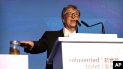 Bill Gates, former Microsoft CEO and co-founder of the Bill and Melinda Gates Foundation, gestures to a container of human feces as he speaks at the Reinvented Toilet Expo in Beijing, Tuesday, Nov. 6, 2018. (AP Photo/Mark Schiefelbein)