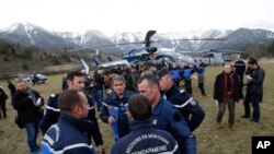 Rescue workers and gendarme gather in Seyne-les-Alpes, French Alps as search-and-rescue teams struggle to reach the remote crash site of Germanwings passenger plane, March 24, 2015.