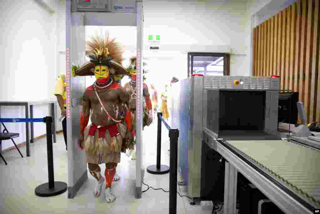 Performers in traditional dresses pass through a security screening at Jacksons International Airport in Port Moresby, Papua New Guinea, ahead of a visit by U.S. Vice President Mike Pence, Nov. 17, 2018.