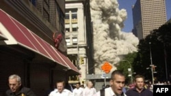 People run from the collapse of the World Trade Center in New York City on September 11, 2001